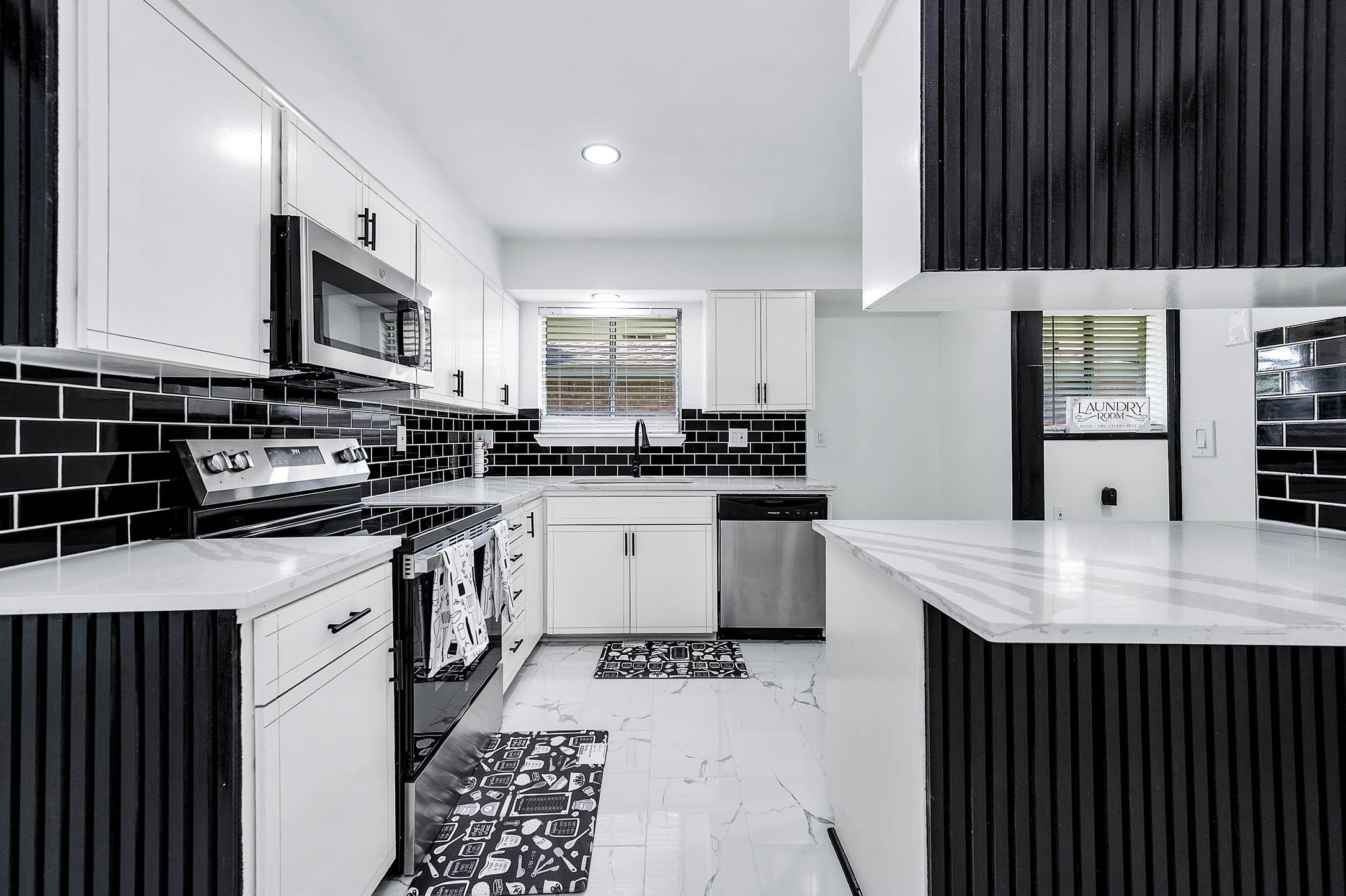 1616 Redway Lane Houston, TX 77062 - Photo 10 of 48 a kitchen with stainless steel appliances a stove a sink a microwave and cabinets