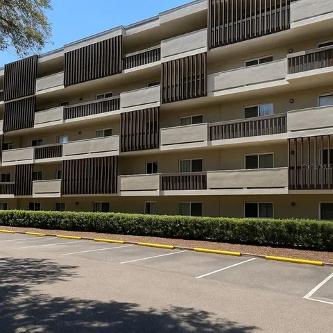 a front view of a building with a garden