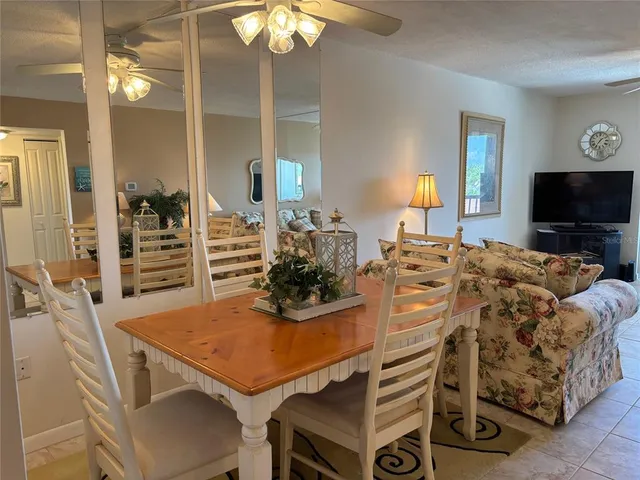 a view of a dining room with furniture and a chandelier
