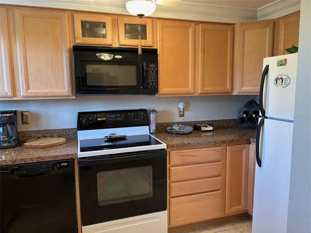 a kitchen with stainless steel appliances a stove a microwave and cabinets