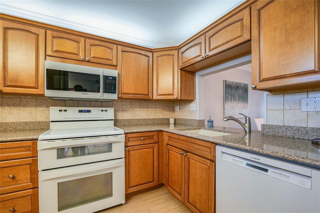3920 Inverrary Boulevard, Unit 604C Lauderhill, FL 33319 - Photo 11 of 54 a kitchen with granite countertop cabinets stainless steel appliances and a sink