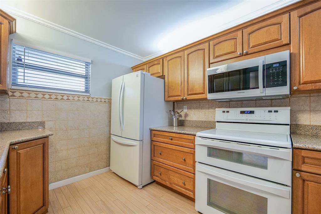 3920 Inverrary Boulevard, Unit 604C Lauderhill, FL 33319 - Photo 12 of 54 a kitchen with granite countertop cabinets and steel stainless steel appliances