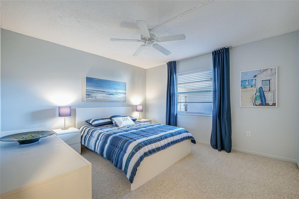 3920 Inverrary Boulevard, Unit 604C Lauderhill, FL 33319 - Photo 17 of 54 a bedroom with a bed and a chandelier