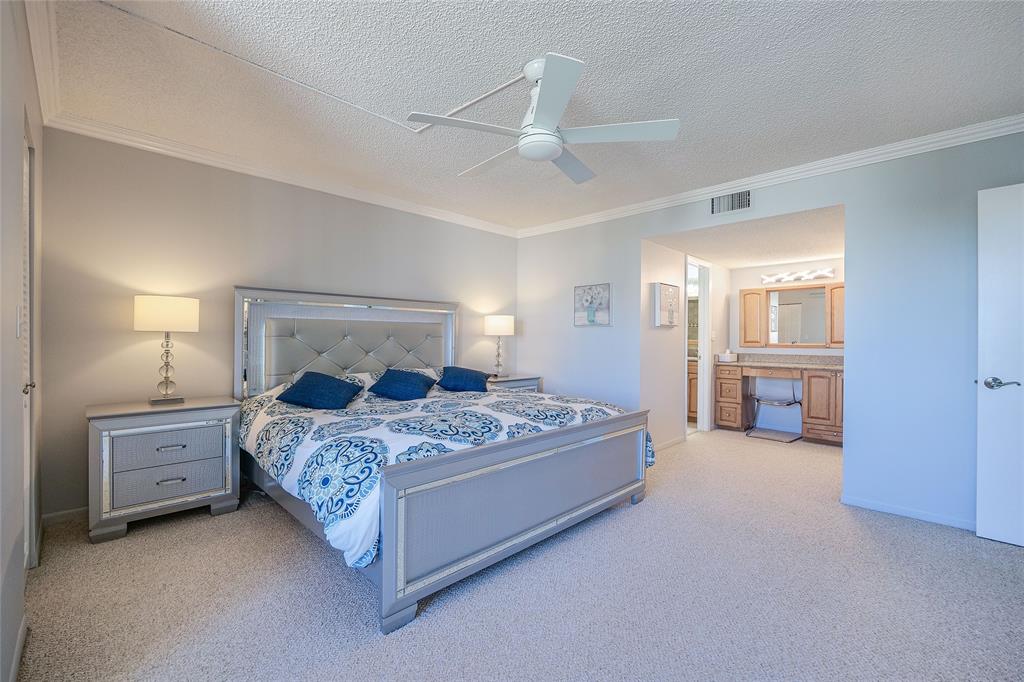 3920 Inverrary Boulevard, Unit 604C Lauderhill, FL 33319 - Photo 23 of 54 a bedroom with a bed and a cabinets