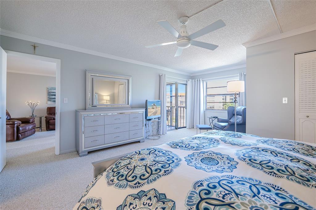 3920 Inverrary Boulevard, Unit 604C Lauderhill, FL 33319 - Photo 25 of 54 a bedroom with a large bed and dresser