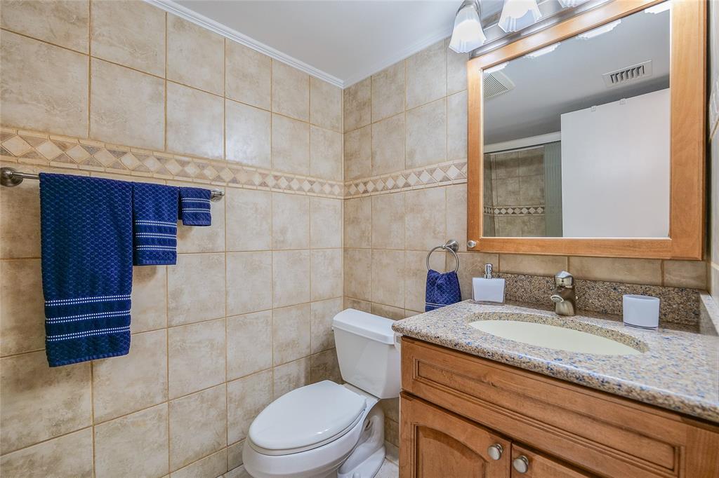 3920 Inverrary Boulevard, Unit 604C Lauderhill, FL 33319 - Photo 29 of 54 a bathroom with a granite countertop toilet sink and mirror