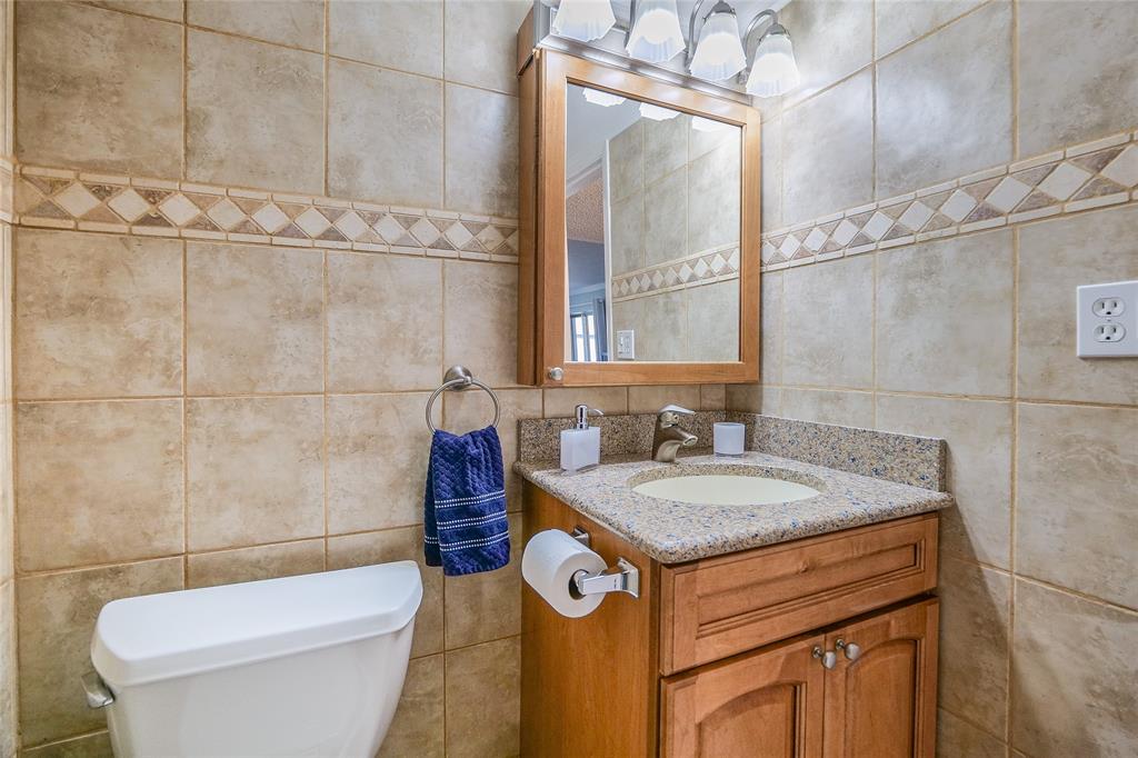 3920 Inverrary Boulevard, Unit 604C Lauderhill, FL 33319 - Photo 30 of 54 a bathroom with a granite countertop sink toilet and mirror