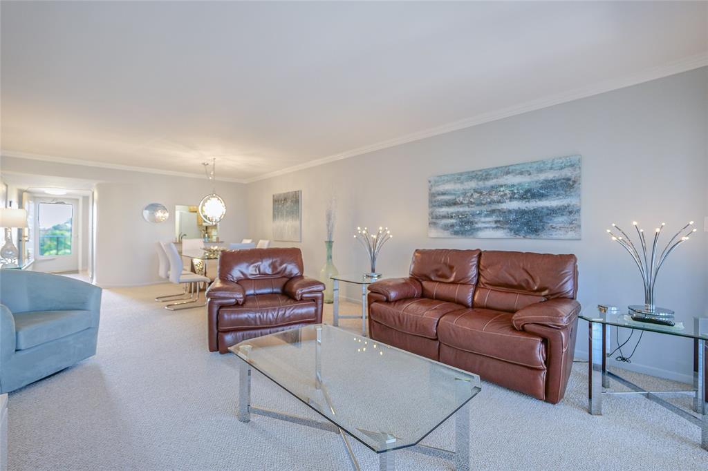 3920 Inverrary Boulevard, Unit 604C Lauderhill, FL 33319 - Photo 4 of 54 a living room with furniture and a lamp