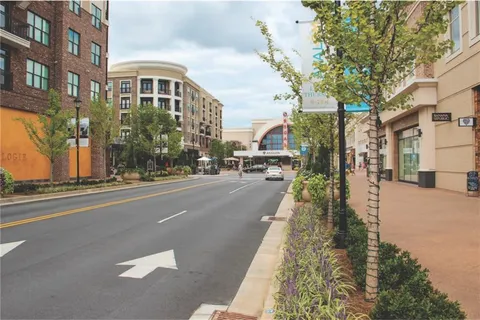 a city street lined with buildings and trees