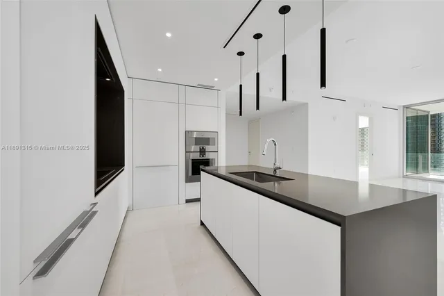 a kitchen with cabinets and a refrigerator