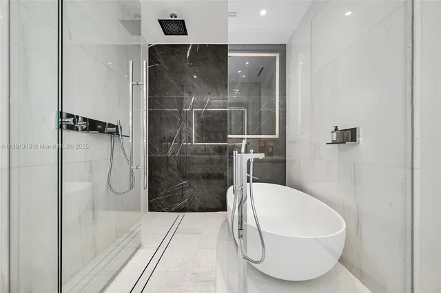 a bathroom with a tub and shower