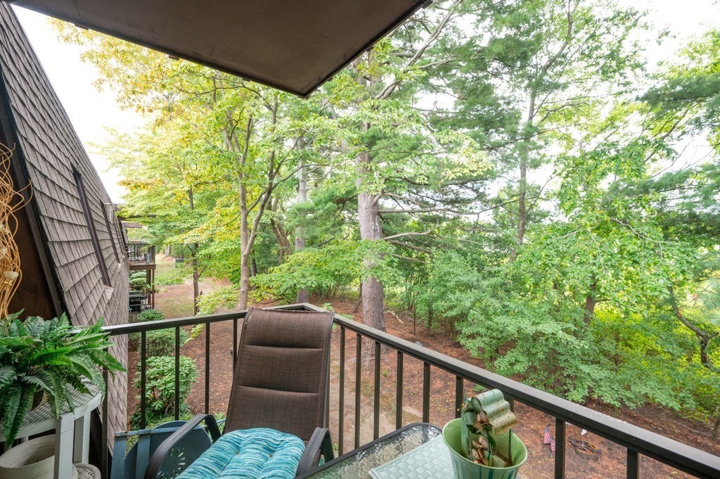 147 Sylvan Street, Unit 18B Danvers, MA 01923 - Photo 12 of 24 a view of a balcony with wooden fence and floor