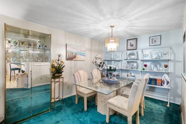 a dining room with furniture and a chandelier