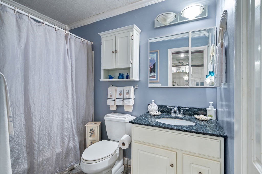 147 Sylvan Street, Unit 18B Danvers, MA 01923 - Photo 15 of 24 a bathroom with a granite countertop sink toilet and mirror