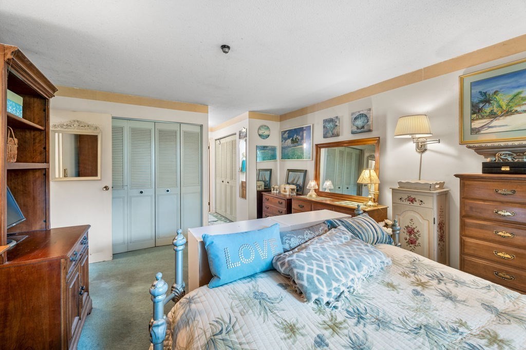 147 Sylvan Street, Unit 18B Danvers, MA 01923 - Photo 18 of 24 a bed room with a bed and furniture