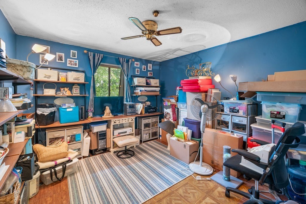 147 Sylvan Street, Unit 18B Danvers, MA 01923 - Photo 20 of 24 a work room with furniture and a book shelf