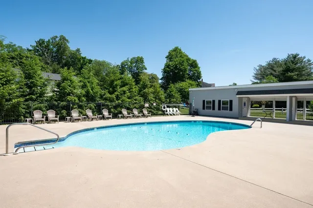 a front view of a house with a yard and trees
