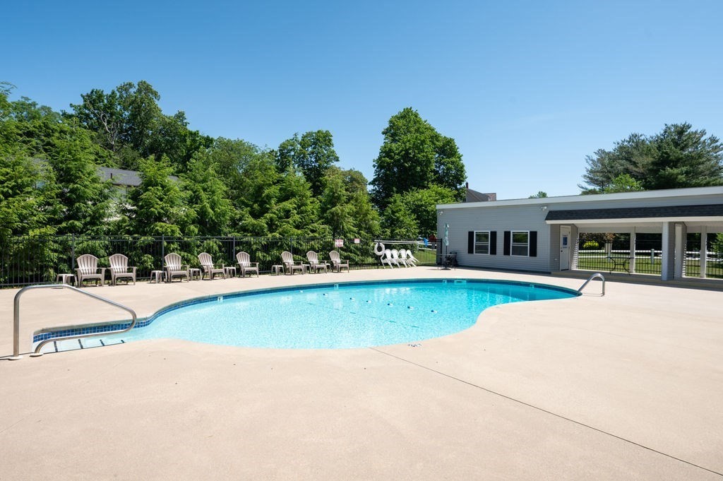 147 Sylvan Street, Unit 18B Danvers, MA 01923 - Photo 22 of 24 a front view of a house with a yard and trees
