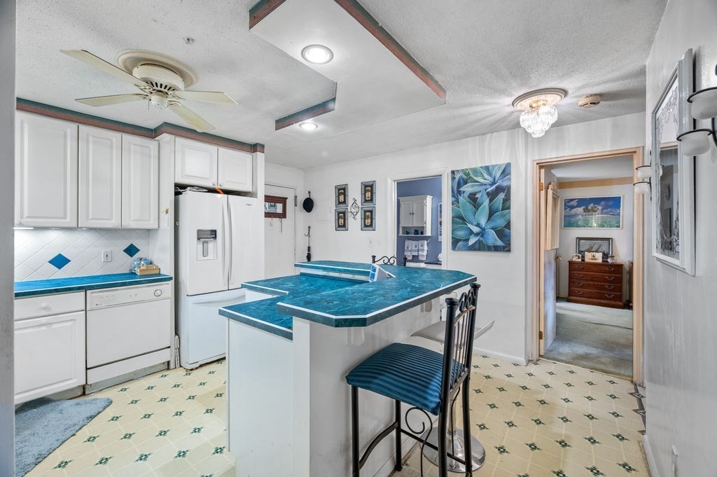 147 Sylvan Street, Unit 18B Danvers, MA 01923 - Photo 4 of 24 a kitchen with granite countertop appliances a sink and a refrigerator