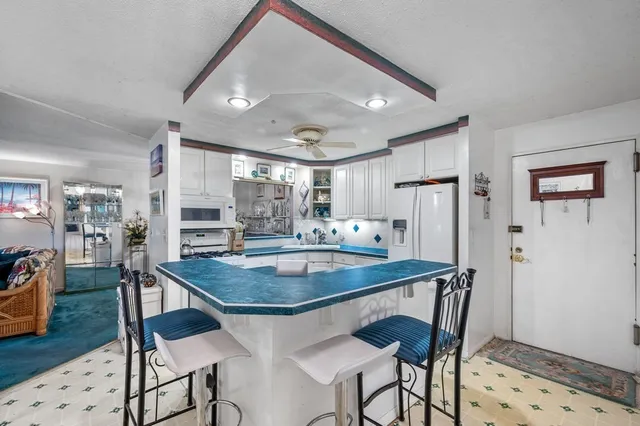 a dining room filled chandelier and wooden floor