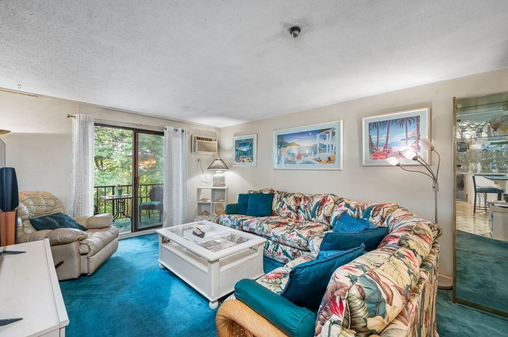 147 Sylvan Street, Unit 18B Danvers, MA 01923 - Photo 8 of 24 a living room with furniture and a large window