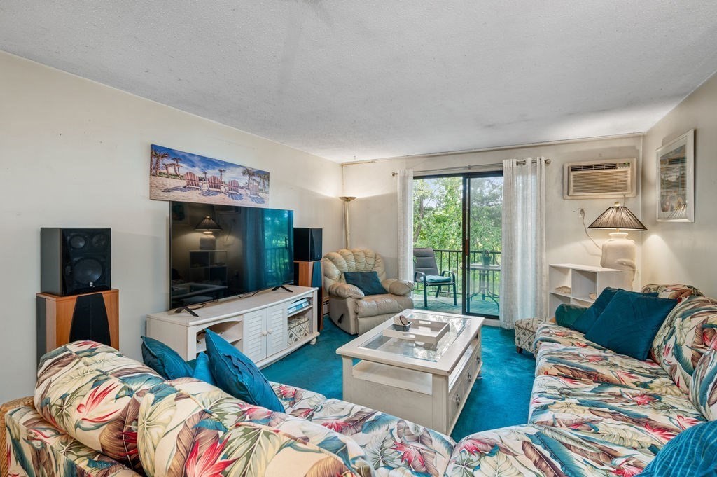 147 Sylvan Street, Unit 18B Danvers, MA 01923 - Photo 9 of 24 a living room with furniture and a flat screen tv