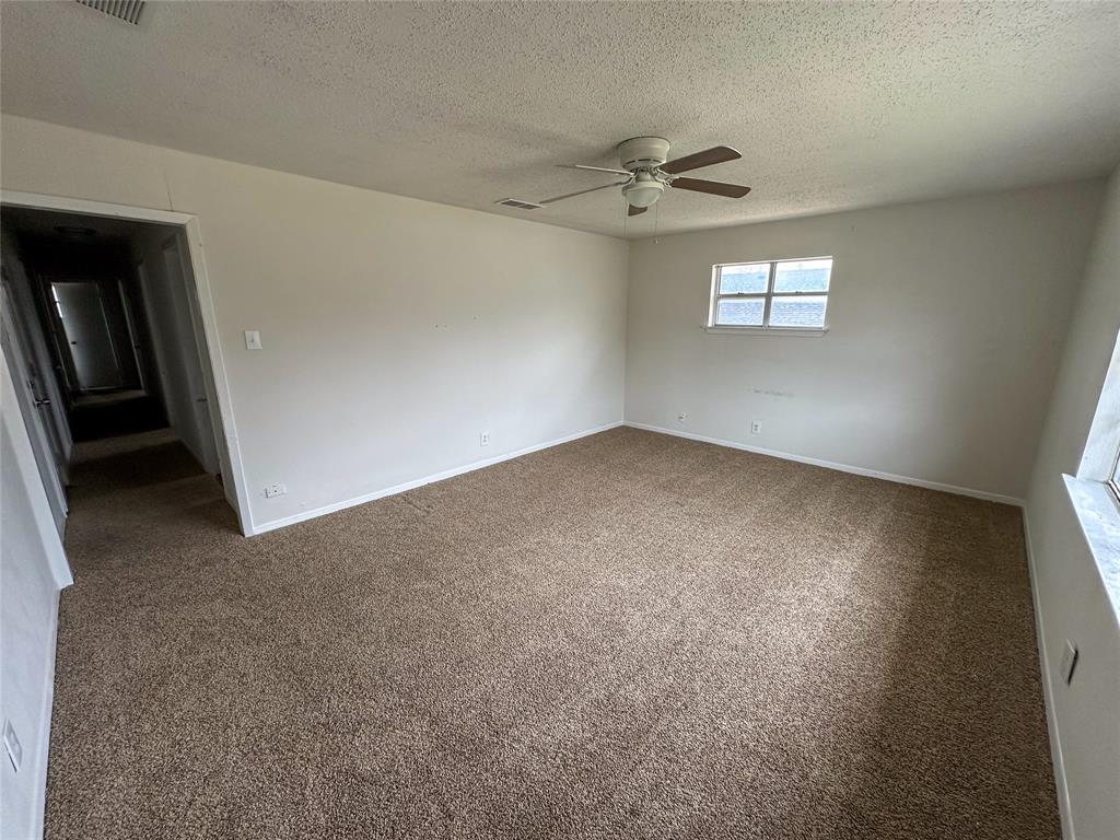 1016 West Gandy Street, Unit 4 Denison, TX 75020 - Photo 3 of 11 a view of an empty room with a window