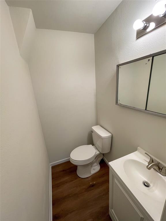 1016 West Gandy Street, Unit 4 Denison, TX 75020 - Photo 10 of 11 a bathroom with a sink a toilet and mirror