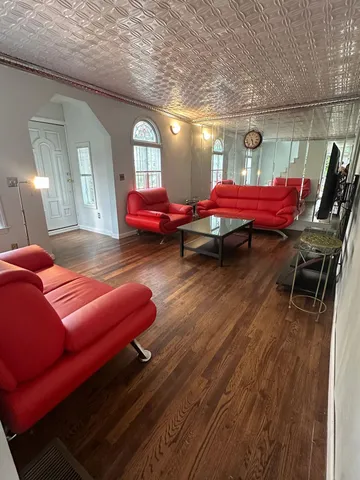 a bedroom with furniture and wooden floor