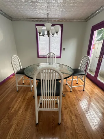 a view of a dining room with furniture wooden floor and chandelier