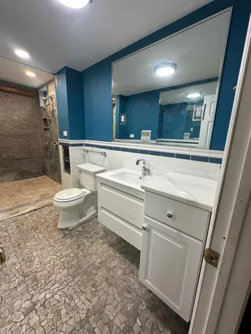a bathroom with a sink a toilet and a mirror