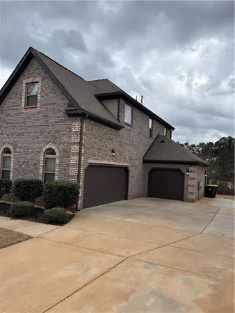 a front view of a house with yard and garage