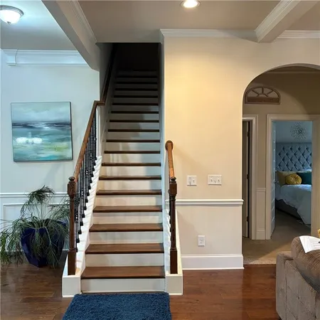 a view of entryway and hall with wooden floor