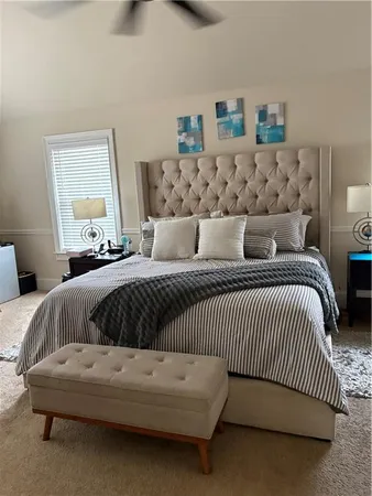 a bedroom with a white bed and a couch