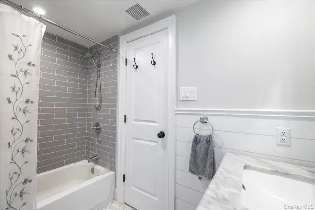 a bathroom with a toilet sink and shower