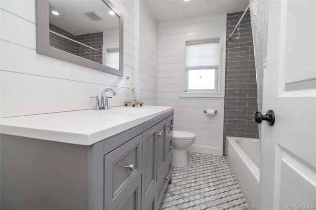 a bathroom with a sink a toilet and bathtub