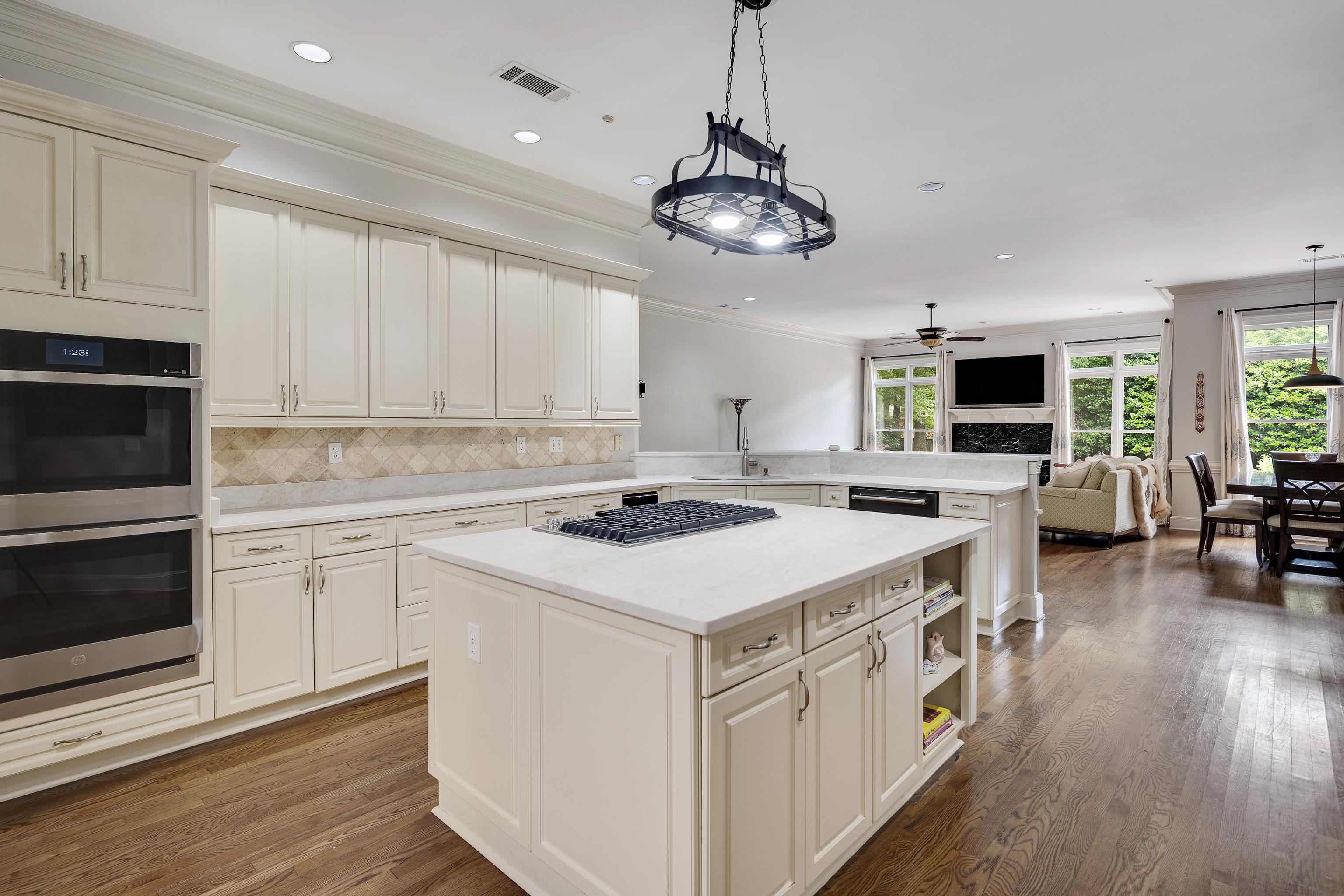 350 Bluff Ridge Cove Memphis, TN 38018 - Photo 18 of 37 Kitchen featuring light-toned cabinetry, stainless steel double wall ovens, a center island with cooktop, and light-toned countertops
