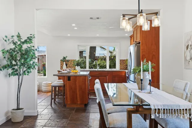a kitchen with stainless steel appliances granite countertop a refrigerator and a stove
