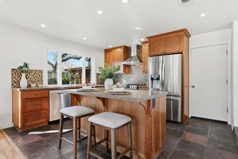 a kitchen with stainless steel appliances a sink and a refrigerator
