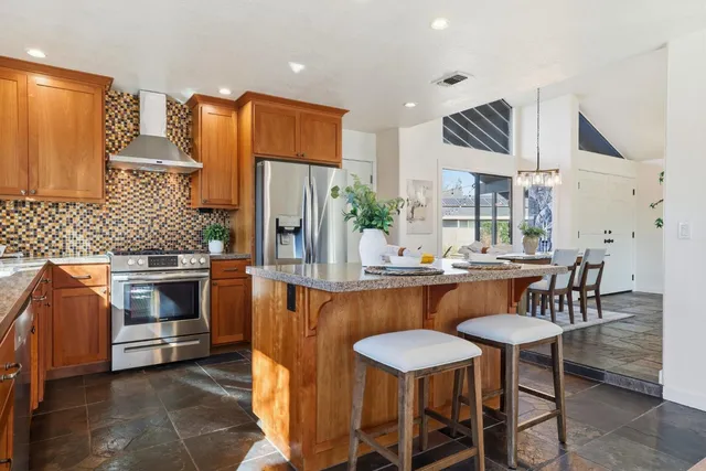 a kitchen with wooden cabinets and a window