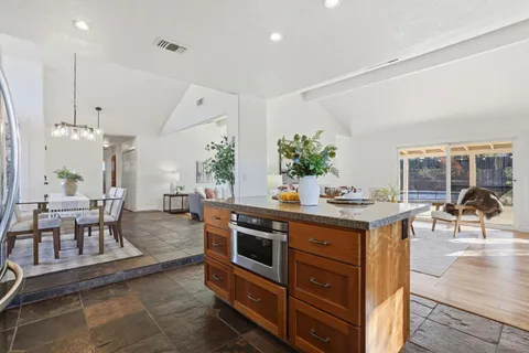 a kitchen with stainless steel appliances granite countertop a stove and a sink