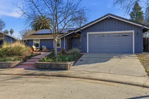 a front view of a house with outdoor seating
