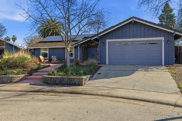a front view of a house with outdoor seating