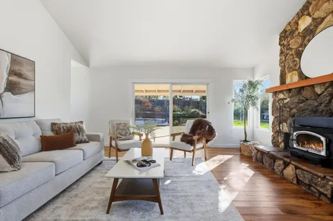 a living room with furniture and kitchen view