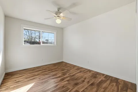 a bedroom with a bed and painting on the wall