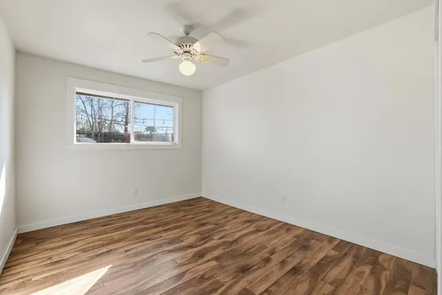 a bedroom with a bed and painting on the wall