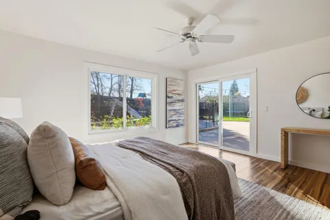 a bathroom with a granite countertop shower a sink and toilet