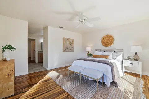 a view of a house with backyard and tree