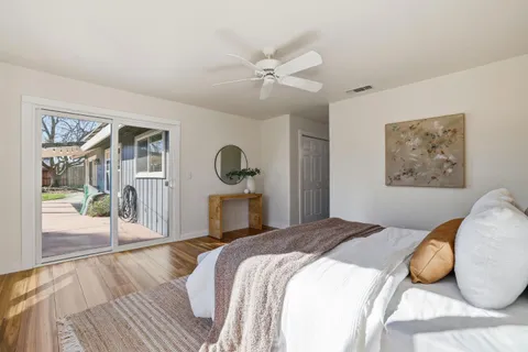 a view of a house with backyard and a tree