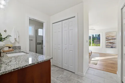 a view of a house with a big yard and potted plants